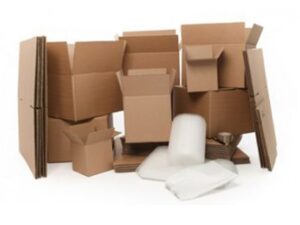 Group of cardboard boxes, bubble wrap, and packing materials arranged on a white background.